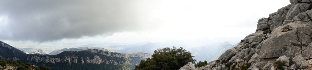 Fototapeta premium Rocky mountains and a clouded sky