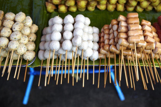 Skewers of streetfood on a table in Thailand.