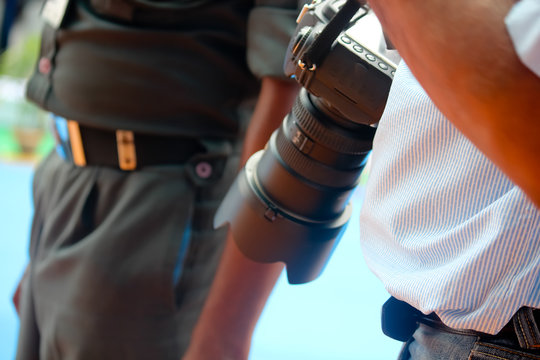 Photographer holding camera.