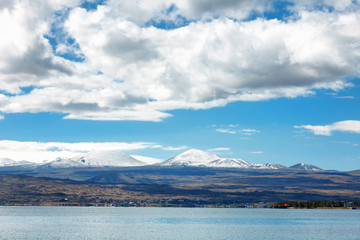 Fototapeta na wymiar Sevan lake and white clouds blue sky on a sunny day, Armenia