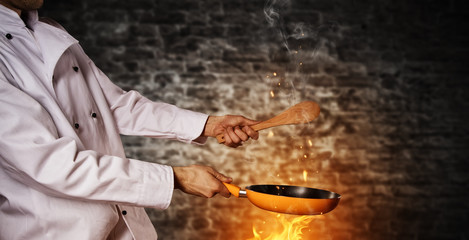 Closeup of chef holding empty grill pan
