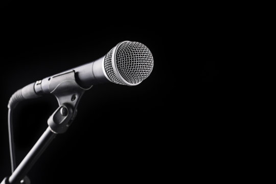 Microphone on stand on black background