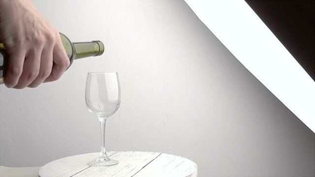 Slow motion shot of Pouring red wine into glass