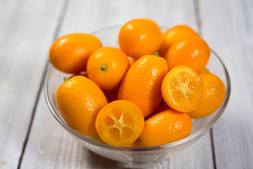 Kumquat in a plate,Raw Organic Orange Kumquats,Small oranges. Chinese orange. Oval oranges.Close up