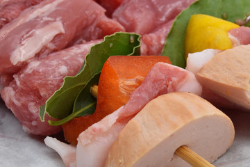 Meat skewers with sausage, pork, beef, peppers and laurel leaf