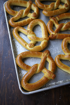 Large pretzels on a cookie sheet with salt.