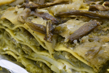 Close up of vegetarian lasagna with artichokes and pesto (Italian basil paste)