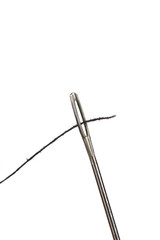 Sewing needle and black thread, macro closeup
