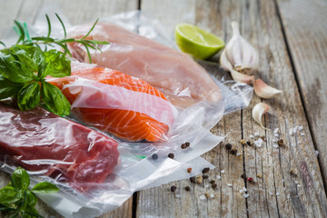 Beef, chicken and salmon in vacuum plastic bag for sous vide cooking - obrazy, fototapety, plakaty