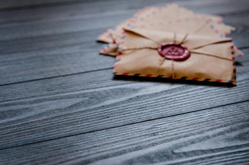 Old vintage retro envelopes with a wax stamp on old dark brown wooden table