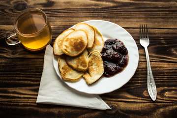 plate with vegan pancackes with jam fork