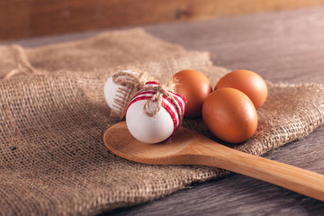 Eggs on sackcloth on wooden table, happy easter concept