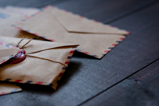 Old vintage retro envelopes with a wax stamp on old dark brown wooden table