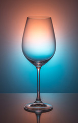 Wine glass on color background