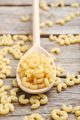 Pasta penne on the grey wooden table