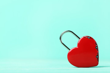 Heart shaped padlock on green background