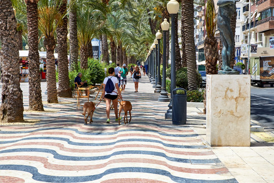Alicante, Spain - June 30, 2016: The promenade Explanada of Spain in Alicante is paved with 6.5 million marble floor tiles creating a wavy form and is one of the most lovely promenades in Spain.