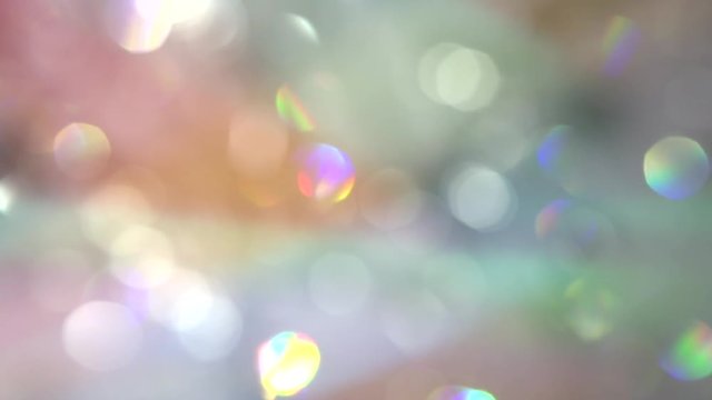 Shimmering background, bokeh. Crystal chandelier shot with blurred focus. Hanging diamonds with blinking shining reflection. Slow motion 240 fps.
