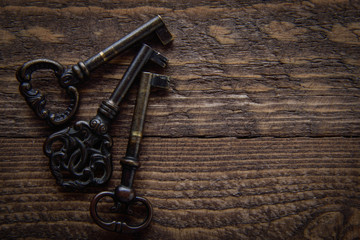 Vintage key on a wooden chocolate background 