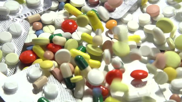 Medical pills falling down. Medicine concept. Treatment Many coloured capsules, pills. Full HD. Slow motion 240 fps. HD 1080p 