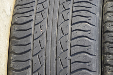 Fototapeta na wymiar The background of the tread pattern of the car wheel. Rubber tir