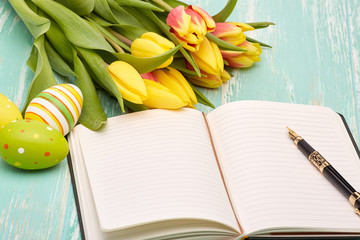Easter eggs, blank daily log and tulips.