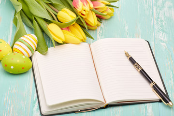 Easter eggs, blank daily log and tulips.
