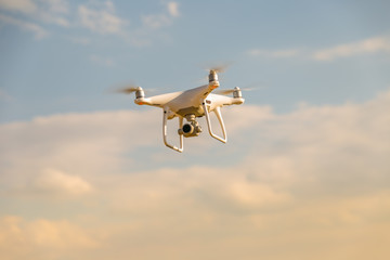 Drone flying in the setting sun