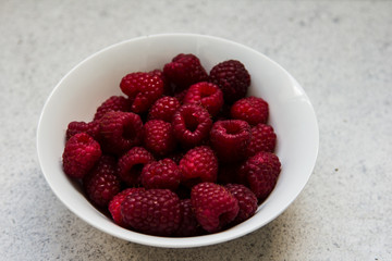 raspberries in a white plate