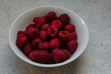 raspberries in a white plate