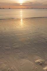 Sea and calm water surface at sunset.
