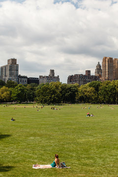 Woman Sunbathing In Central Park, Manhattan.