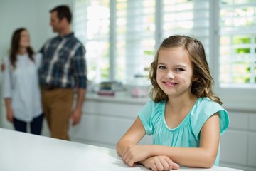 Portrait of smiling girl sitting in living room