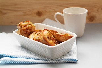 homemade muffins on plate beside cup with a drink