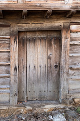 Small light brown wooden door made of planks