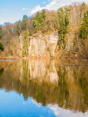 Sandstone rock formations reflected in the water. Plakanek Valley in Bohemian Paradise, aka Cesky Raj, Czech Republic, Europe.