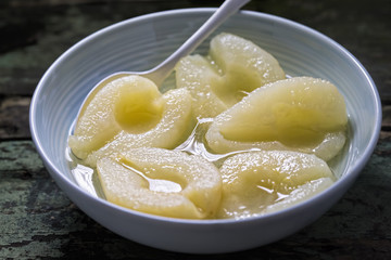 Pears in syrup in blue bowl  - 140697912