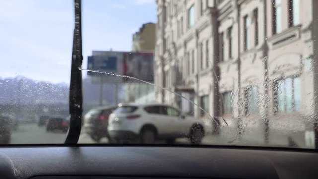 Windshield wiper and car windscreen washer in slow motion