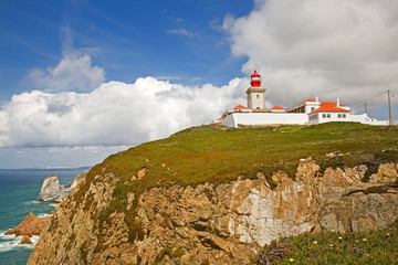 Fototapeta na wymiar Lighthouse and cliffs of Far West, Portugal. The most westerly point in Europe.