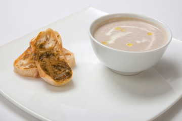 Soup puree mushrooms in a deep white plate