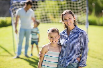 Portrait of mother and daughter standing in park