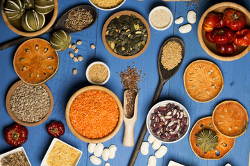 Various dried legumes in bowls for background, Raw legume on old rustic wooden table, Healthy protein food. Place for typography, top view