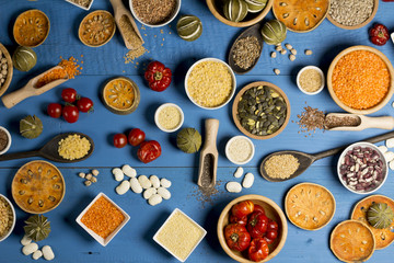 Various dried legumes in bowls for background, Raw legume on old rustic wooden table, Healthy protein food. Place for typography, top view