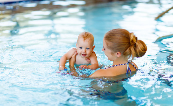 Mother and baby swim  in pool