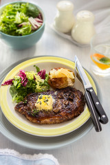Summer steak with baked potato and salad 