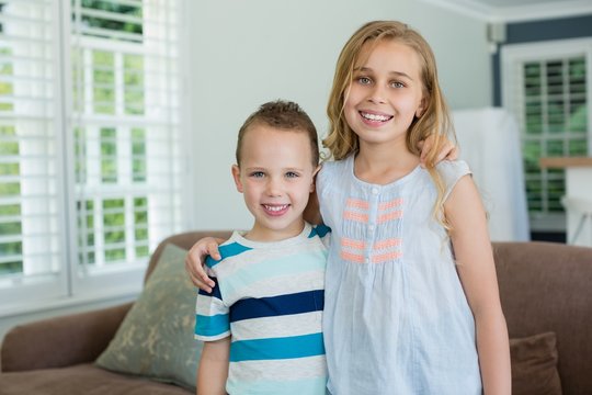 Portrait Of Smiling Sister And Brother Standing 