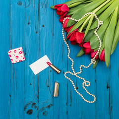 red tulips on a blue wooden board