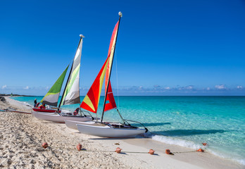 Two sailing catamarans on the beach