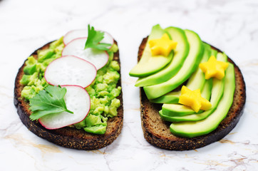 Avocado mango and smashed avocado radish parsley rye breakfast sandwiches