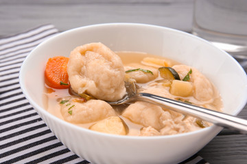 Portion of delicious chicken and dumplings on dining table